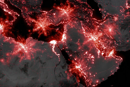 Satellite imagery map of Middle East at night showing illuminated cities and road networks with glowing red highlights creating dramatic and intense visual effect