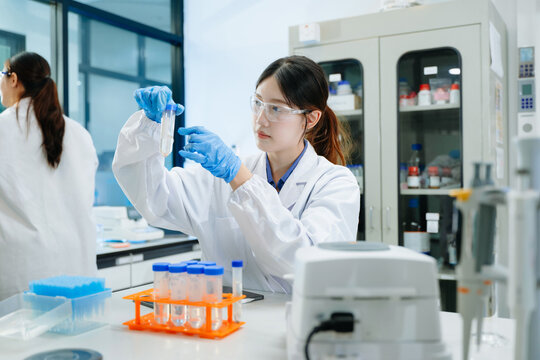 A scientific research team collaborating in a modern laboratory, conducting experiments, analyzing samples, and using advanced lab equipment
