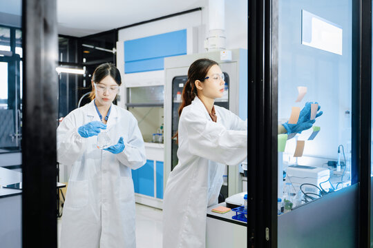 A scientific research team collaborating in a modern laboratory, conducting experiments, analyzing samples, and using advanced lab equipment