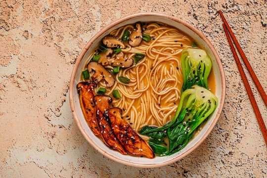 Vegan miso ramen noodle soup with eryngii and shiitake mushrooms, pak choi cabbage