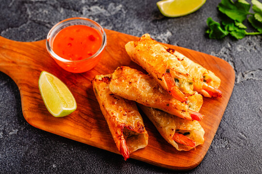 Fried spring rolls with shrimps served with sauce and lime