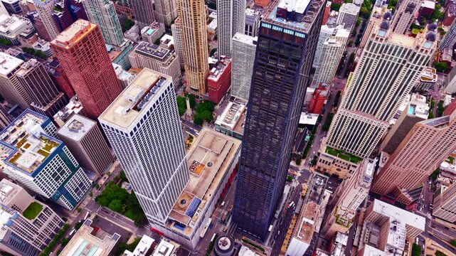 Downtown Chicago rooftops. Top down drone perspective of dense skyscraper clusters, streets and green rooftop gardens in the financial district. Aerial view.