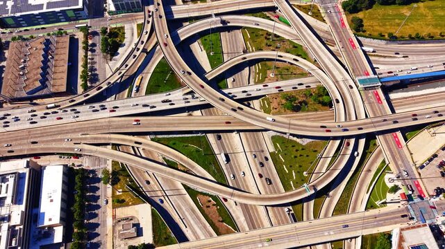 Overhead view of highway cloverleaf interchange i290 and i90, Chicago Illinois. Top down drone perspective of curving expressway ramps, traffic lanes and green medians near downtown.