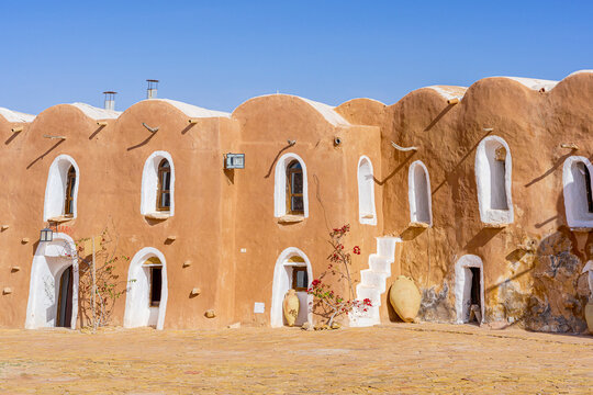Traditional adobe granary with whitewashed doorways