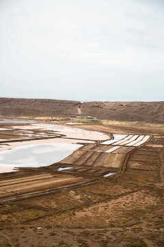 Vast salt evaporation ponds on an overcast day