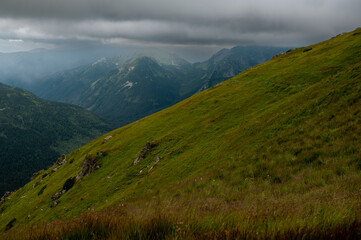 Fototapeta premium Dramatic mountain landscape with green slopes and stormy skies over the Tatras