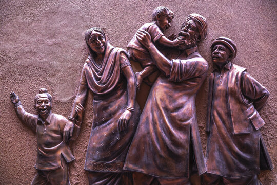 A sculpture at Jallianwala Bagh in Amritsar, India, depicting a Sikh family in traditional dress,