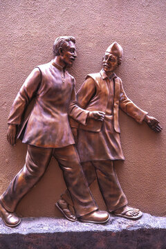 A bronze sculpture depicting two men walking and talking, located in Jallianwalla Bagh, Amritsar, in the Punjab region of India, commemorating a historic moment.