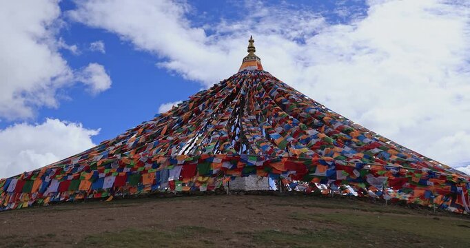 The Changqing Chunker Temple  in Litang, China. Many colourful prayer flags on the mountain top beside the temple.Spirituality and meditation.