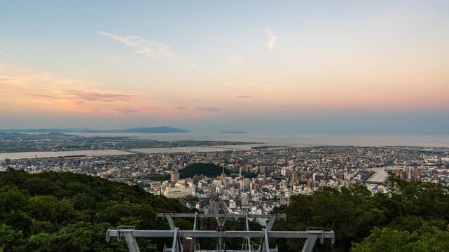 Timelapse footage of Tokushima city center from Mount Bizan transitioning from magic hour to glowing nightscape.