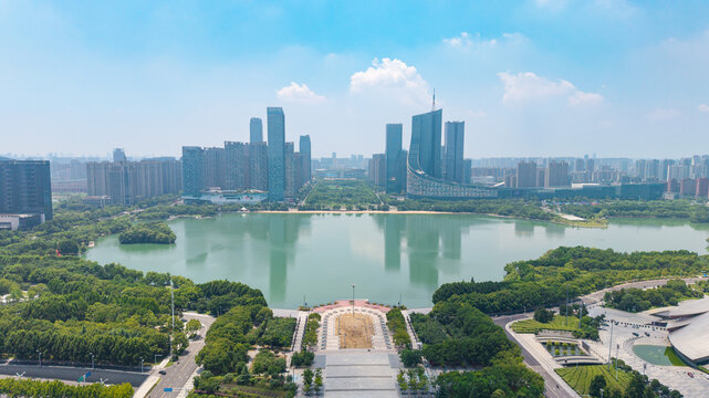 Aerial view of modern city CBD skyline with skyscrapers reflecting in calm lake water