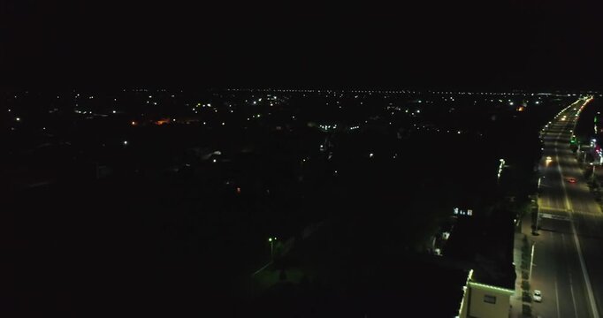 The drone flies at night over the illuminated streets and roads of the old city. Bukhara, Uzbekistan.