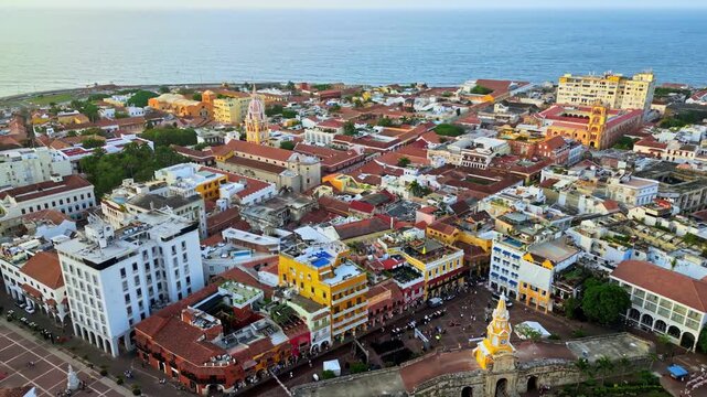 Cartagena aerial cinematic view from walled city clock tower over historic colonial plaza buildings.
