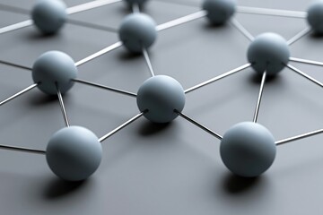 Fototapeta premium Matte spheres connected by thin metallic rods forming an organized network on gray surface