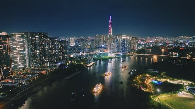 Aerial View of Dinner Cruise Boat Navigating Saigon River at Night in Ho Chi Minh City, Vietnam
bright boat searchlights, colorful reflections across the water, the lit-up cable-stayed bridge