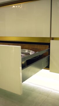 Modern kitchen drawer interior. Luxury modular kitchen cabinet with soft close mechanism.