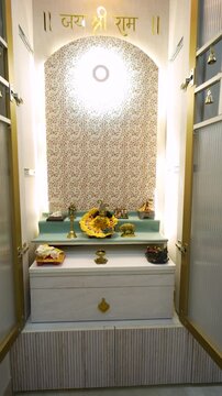 Hindu deity idol in home temple. Traditional Indian prayer altar with Krishna statue.