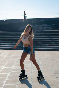 Young woman enjoying rollerblading outdoors on a sunny day