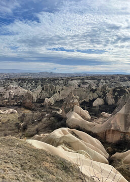 Panoramic view of Cappadocia fairy chimneys and volcanic tuff formations with Mount Erciyes in the distance, Turkey