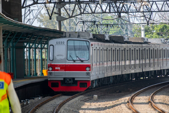 Jakarta, Indonesia - July 29, 2026: KAI Commuter Tokyo Metro 6000 series train arrives at the platform beneath a steel catenary truss at JIS Station.