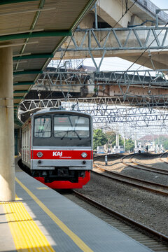 Jakarta, Indonesia - July 29, 2026: KAI Commuter JR 205 series train arrives at the platform beneath the Jakarta Inner Ring Road at JIS Station.
