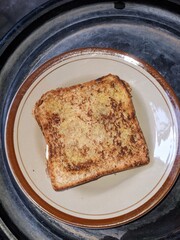 toast taken from a top view, with a crispy texture in dim lighting © Setarr