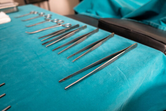 Surgery tools on sterile blue drape in operating room preparing for surgery