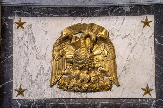 Paris, France. Saint Sulpice Church. A gilded relief sculpture depicting a pelican feeding its young, with the inscription &ldquo;Pietas&rdquo; above it.