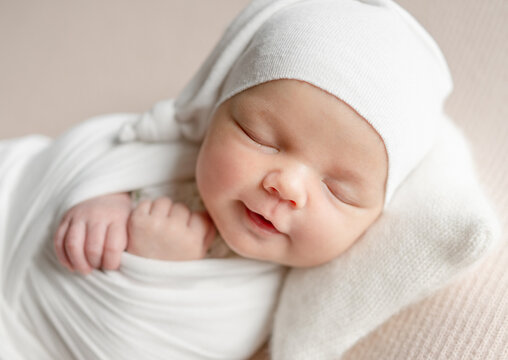 Newborn Girl Smiling And Sleeping At A Newborn Photoshoot