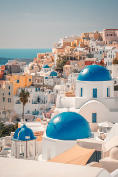 Oia village in santorini island showcasing traditional white buildings and blue domed churches