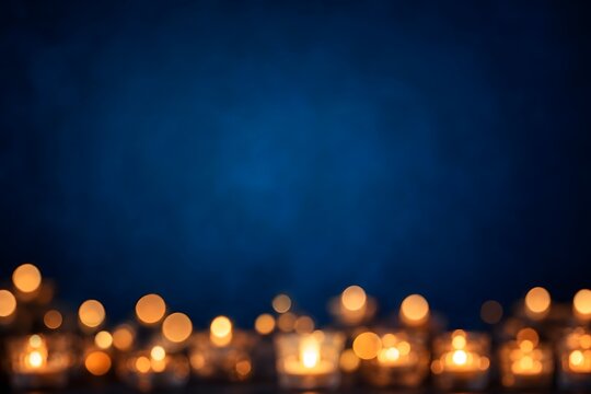 Glowing Tealight Candles with Soft Bokeh Effect on Dark Blue Background