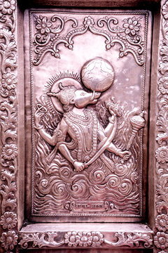 A silver-plated relief sculpture depicting the god Varaha holding the Earth, adorning the Shri Durgiana Temple in Amritsar.
