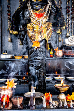 Offerings and lights in a Hindu temple in Palampur, Himachal Pradesh, dedicated to Shani Dev.