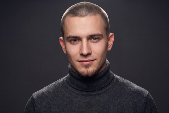 Handsome young man portrait with buzz cut hair and turtleneck sweater