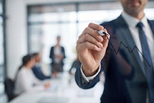 Businessman drawing business growth chart on glass wall in meeting room