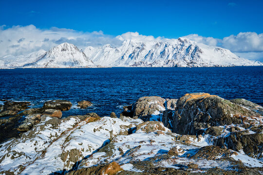 Lofoten islands and Norwegian sea in winter featuring snow covered mountains. Lofoten islands, Norway