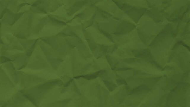 Close-up of green textured paper with crumpled surface. Abstract background for design projects.