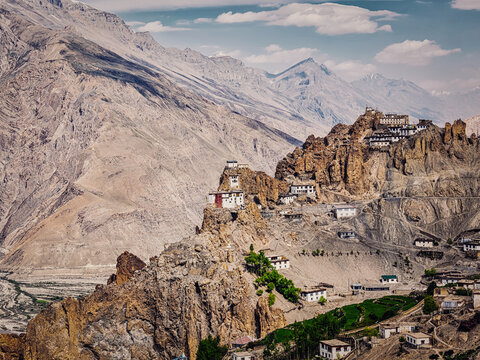 Vintage retro effect filtered hipster style scene of Dhankar gompa Buddhist monastery on cliff and Dhankar village in Himalayas, Dhankar, Spiti valley, Himachal Pradesh, India