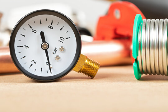 Pressure Gauge and Solder Wire on a Plumber&rsquo;s Workbench