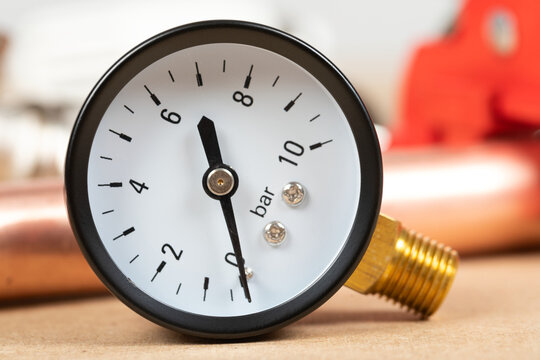 Pressure Gauge and Solder Wire on a Plumber&rsquo;s Workbench