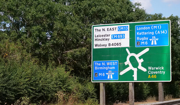 Signpost, road, sign, direction, highway, UK British green motorway directional junction signpost showing routes to London, Leicester and Birmingham