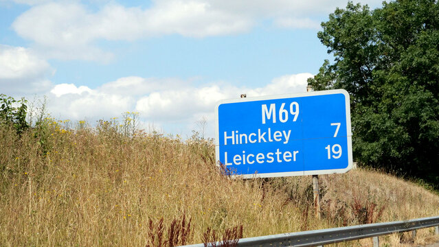 M69, sign, Leicester, Hinckley, motorway, UK blue motorway directional signpost showing distance in miles to Hinckley and Leicester
