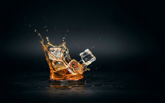 Pure vodka liquid, Refreshing Beverages & Dynamic Liquid Action, Cold refreshing beverage splashing over ice cubes on dark background
