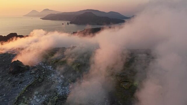 Aerial view of active volcano crater with smoking fumaroles, island of Vulcano in Aeolian archipelago, Sicily. Dramatic volcanic landscape on Vulcano island at sunset, Italy