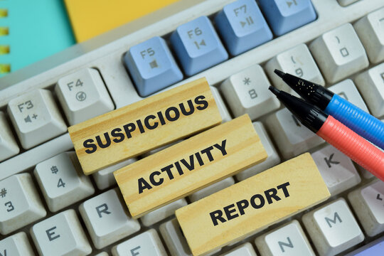 Concept of suspicious activity report text on wooden blocks.