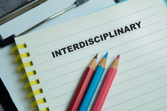 Concept of interdisciplinary write on book isolated on Wooden Table.