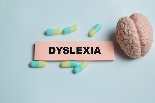 Concept of dyslexia write on sticky notes isolated on Wooden Table.