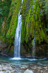 Kaghu Waterfall, located in the Samegrelo region of Georgia, A vibrant waterfall cascades down a mossy stone © k_samurkas