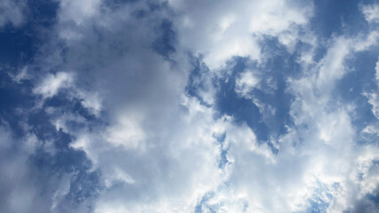 Obraz premium Dense white and grey clouds filling a blue sky