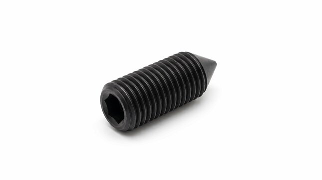 Black steel set screw on white background. Industrial hex socket grub screw for hardware.